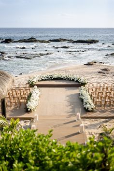 an outdoor ceremony set up on the beach