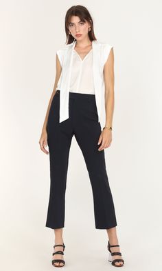 This sleeveless blouse was created for both tailored and casual looks. A modified version of the Edna Neck Tie Blouse, this high-collared piece can still be tied and styled in multiple ways. The tank top feel is comfortable and suitable for adjusting easily between formal and informal meetings. Wearing a blazer or coat over feels even easier without having to adjust sleeves to match. Tie bow blouse Sleeveless Satin Cotton Imported 100% Polyester Length: 24" Chest: 20 1/4" Hand wash in cold water Sleeveless Stretch Blouse For Formal Occasions, Formal Sleeveless Stretch Blouse, Formal Stretch Sleeveless Blouse, Chic Stretch Blouse For Business Casual, Versatile Sleeveless Top For Business Casual, Elegant Sleeveless Tops For Business Casual, Summer Workwear Blouse In Elastane, Spring Stretch Blouse For Business Casual, Elegant Stretch Sleeveless Blouse