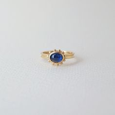 Enchanting beauty of our Nova ring features a striking blue Ceylon sapphire. Hand-carved and delicately designed, this 14k yellow gold ring from our Nova collection will add a touch of dreamy elegance to any outfit. Treat yourself or a loved one to this captivating piece. -hand-carved ring in 14k gold -Ceylon sapphire -signature brushed finish -The ring is made in size 6.5. Resizing available upon request 14k Yellow Gold Sapphire Ring With Halo, Blue 14k Gold Sapphire Ring With Rose Cut Diamonds, Elegant 14k Gold Sapphire Halo Ring, Yellow Gold Sapphire Halo Ring, Heirloom Sapphire Ring With Halo In 14k Gold, Heirloom Yellow Gold Sapphire Ring With Halo, Timeless Blue Sapphire Ring In 14k Gold, Timeless Yellow Gold Sapphire Ring, Blue Celestial 14k Gold Rings