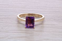 Solid 9ct yellow gold ring set with natural Amethyst Also available in 9ct white gold to order Set with a single emerald cut Amethyst measuring 8 mm x 6 mm British hallmarked Perfect dress ring, engagement ring Comes complete in presentation case Classic Yellow Gold Rectangular Amethyst Ring, Classic Emerald Cut Amethyst Ring, Classic Emerald-cut Amethyst Ring, Classic Emerald Cut Amethyst Ring With Center Stone, Classic Emerald Cut Purple Rings, Formal Solitaire Amethyst Ring With Emerald Cut, Formal Emerald-cut Solitaire Amethyst Ring, Classic Purple Emerald Cut Rings, Classic Emerald Cut Amethyst Ring For Formal Occasions