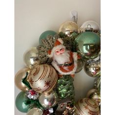 a christmas wreath with santa clause and ornaments