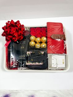 a white tray filled with assorted chocolates and wrapped presents