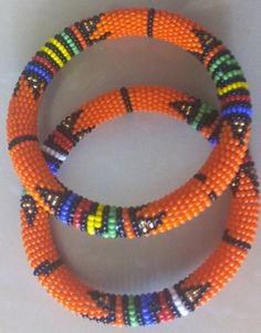 Beaded Bracelets | African Maasai Beaded Bracelets | African Jewelry | Zulu Beaded Bracelets | Ethnic Bracelets | Gift For Her | A Set Of Two These superbly crafted Zulu beaded bracelets are made of fine beads.The price is for a set of two bracelets.Main Color - Orange.Standard measurement is 7 - 8 inches.For smaller or bigger size please contact me.Available in different colors.Feel free to send me a convo or e-mail for any clarification.Thank you for visiting... Bohemian Beaded Bracelets For Festivals, Traditional Round Beaded Bracelets For Festival, Orange Beaded Bohemian Friendship Bracelets, Traditional Hand-strung Stretch Bracelet For Festivals, Bohemian Orange Beaded Friendship Bracelets, Orange Bohemian Beaded Friendship Bracelets, Traditional Hand-strung Stretch Bracelet, Orange Bracelets As Festival Gifts, Orange Bohemian Bracelets With Spacer Beads