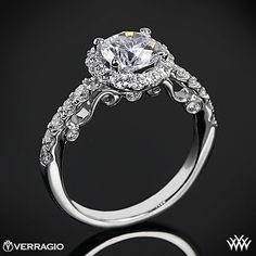 an engagement ring with two rows of diamonds on the band and a center stone in the middle