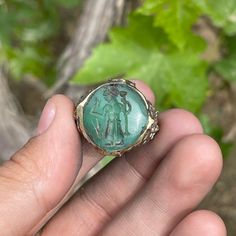 a person holding a ring with an image on it