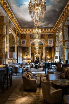 a fancy hotel lobby with chandelier and seating area in the foregrounds