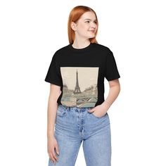 Embrace the romance and elegance of France with our France T-Shirt, featuring a beautifully designed image of the iconic Eiffel Tower, the heart of Paris and a symbol of timeless beauty. This t-shirt is more than just clothing; it's a piece of Paris you can wear, making it the perfect souvenir for travelers and a delightful gift for anyone enchanted by the City of Light. This classic unisex jersey short sleeve tee fits like a well-loved favorite. Soft cotton and quality print make users fall in Vintage Short Sleeve Tops For Gift, Vintage Graphic Print Tops As Gift, Vintage Graphic Print Tops For Gifts, Vintage Black Top Gift, Vintage Black Top As Gift, Black Vintage Top Gift, Gift Retro Black T-shirt, Vintage Parisian, Paris Tour