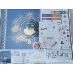 an open harry potter planner book with hogwarts symbols and stickers on it