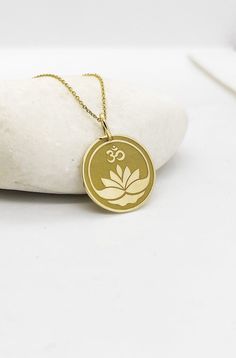 14K Real Solid Gold Necklace, Hallmarked on the back of your pendant for certification! ▪️ A beautiful and clean engraved Om Lotus  pendant made out of 14K Solid Real Gold. Available only in yellow gold! Pendant Thickness: 0.50mm Jump Ring inner diameter: 4mm Dimensions: - 13mm / 0.52 inches - 15mm / 0.59 inches - 18mm / 0.70 inches - 20mm / 0.78 inches - 22mm / 0.86 inches - 24mm / 0.94 inches Necklace Length - You can choose your chain length from 35CM to 50CM. The pendant is available alone w Spiritual Round Pendant Jewelry With Engraving Option, Spiritual Medallion Jewelry With Engraving Option, Symbolic Yellow Gold Jewelry With Engraving Option, Symbolic Etched Jewelry For Commemoration, Spiritual 14k Stamped Round Pendant Jewelry, Yellow Gold Jewelry With Engraving For Commemoration, Spiritual Necklaces With Engraving Option For Commemoration, Spiritual Etched Yellow Gold Necklace, Round Etched Necklaces For Commemoration