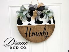 a door hanger with a cow painted on it that says,'hoddy diane and co '