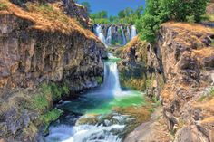 there is a waterfall that has green water in it