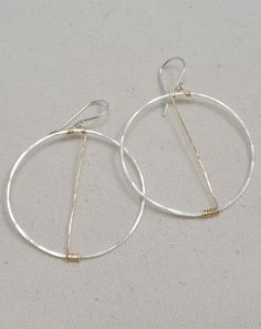 We love these minimal hoops with a gold slash to add interest! Wrapped and hammered by hand, the traverse hoop earrings are super lightweight and hang about 2" from the top of the earwire. A simple, beautiful gift for yourself or anyone on your list! •Made of sterling silver and 14K gold filled wire. •Circles measure 1.5 inches and hang 2" from the top of the earwire. •Earrings come in a gift box with ribbon. Gift Box With Ribbon, Handmade Jewelry Designs, Trendy Jewelry, You Are Beautiful, Clover Leaf, Gold Hoop, Silver And Gold, Gold Hoop Earrings, Artisan Jewelry