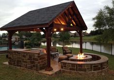 an outdoor fire pit with seating around it