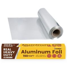 a roll of aluminum foil sitting on top of a white table next to a box