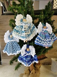 a crocheted christmas tree decoration with blue and white doily on the top