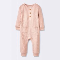 Keep your little one nice and cozy by dressing them up in the Sweater Romper from cloud island™. This Henley romper is made from 100% cotton fabric to offer soft and breathable comfort all day long. This pink sweater romper features jacquard-knit detailing for texture and artistic style. The front pockets add to the look, while the ribbed cuffs and hem offer a snug fit. Designed with a Henley neckline, this long-sleeve romper includes front buttons and crotch snaps for quick and easy dressing an Winter Cotton Bubble Romper With Long Sleeves, Winter Long Sleeve Cotton Bubble Romper, Playful Long-sleeve Bubble Romper For Loungewear, Playful Long Sleeve Bubble Romper For Loungewear, Solid Long Sleeve Onesie For Bedtime, Casual Cotton Bubble Romper For Bedtime, Long Sleeve Cotton Bubble Romper For Loungewear, Solid Long Sleeve Bedtime Onesie, Cozy Cotton Jumpsuits And Rompers For Loungewear