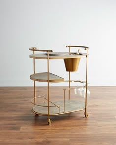 a gold serving cart with two pots on it