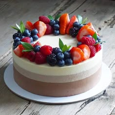 a cake with berries and blueberries on top