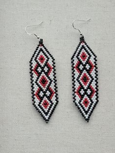 Traditional Red Earrings With Black Beads, Artisan Red Jewelry With Black Beads, Artisan Earrings With Black Beads As Gift, Red Earrings With Black Beads As Gift, Red Earrings With Black Beads For Gift, Red Southwestern Style Earrings With Round Beads, Southwestern Red Beaded Earrings As Gift, Southwestern Black Beaded Earrings For Gift, Southwestern Style Red Beaded Earrings As Gift