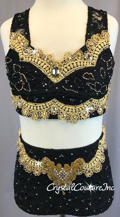 a black top with gold sequins on the bottom and an embellished belt