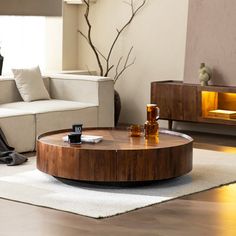 a living room filled with furniture and a fire place next to a white rug on top of a wooden floor