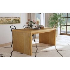 a wooden table sitting on top of a white rug