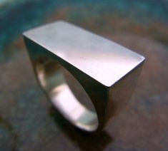 The most perfect statement male ring made of sterling silver rectangle. Simple lines, modern and classic at the same time. shiny and impressive. 23/12 mm on top. Another signet ring you can find here: https://www.etsy.com/il-en/listing/188742177/signet-ring-man-silver-ring-men-signet?ref=sr_gallery_5&ga_search_query=signet+ring+men&ga_page=2&ga_search_type=all&ga_view_type=gallery Male Ring, Ring Rectangle, Silver Mens Ring, Gold Jewelry Outfits, Harry Potter Jewelry, Man Ring, Signet Ring Men, Silver Necklaces Women, Sterling Silver Mens Rings