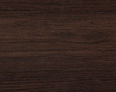 a close up view of the wood grains on this table top, which is dark brown