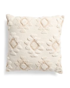 a white pillow with an embroidered design on it