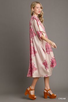 The Satin Breeze Border Print Kimono is an elegant and lightweight layering piece that adds a touch of sophistication to any outfit. Crafted from 100% polyester, this kimono features a smooth, silky satin finish that drapes beautifully over the body. The open front design allows for effortless styling, while the intricate border print adds a touch of artistry and visual interest. Short sleeves make it perfect for warmer weather, and the flowy silhouette enhances its relaxed, bohemian vibe. Fit & Spring Silk Kimono With Kimono Sleeves, Elegant Flowy Wrap Kimono, Spring Silk Kimono For Daywear, Spring Feminine Robe With Kimono Sleeves, Satin Kimono For Daywear, Spring Daywear Satin Robe, Spring Satin Daywear Robe, Spring Satin Robe For Daywear, Spring Silk Kimono For Loungewear