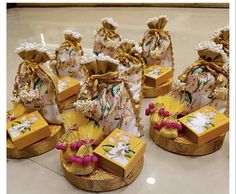 several small bags with bows and pearls on them are sitting on the floor next to each other