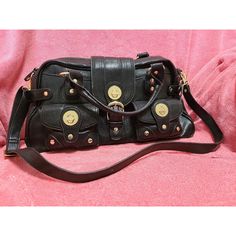 ~ Black Simulated Leather With Gold Accents London Fog Purse ~ Brand New, Original Price Tag Still Attached ~ 16.5" 8" 5.5" ~ The Inside Has A Small Zipper Compartment On One Side And Two Regular Compartments On The Other Side ~ Two Functional Pockets With Buckles On The Front ~ Zipper Closure And Buckle Latch ~ Shoulder Strap Is Removable ~ Originally $70, But Open To Reasonable Offers ~ Please Do Not Hesitate To Message Me If You Have Any Questions Or Would Like To See More Pictures! :) Designer Crossbody Satchel With Branded Hardware For Daily Use, Designer Crossbody Satchel For Daily Use, Daily Use Designer Satchel With Branded Hardware, Black Travel Satchel With Metal Hardware, Black Satchel With Metal Hardware For Travel, Black Handheld Shoulder Bag With Metal Hardware, Daily Use Shoulder Bag With Branded Hardware, Handheld Satchel With Metal Hardware For Daily Use, Trendy Shoulder Bag With Branded Hardware For Everyday Use