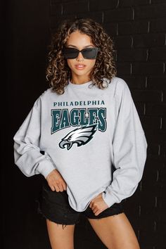 PHILADELPHIA EAGLES FIGHTING SPIRIT RELAXED FIT HEATHERED LONG SLEEVE FRENCH TERRY PULLOVER Holiday Graphic Tees, Gameday Couture, Nfl Fans, Team Apparel, Ribbed Neckline, New York Jets, Philadelphia Eagles, Oversized Tee, College Outfits