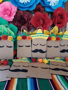 some paper bags with flowers and mustaches on them