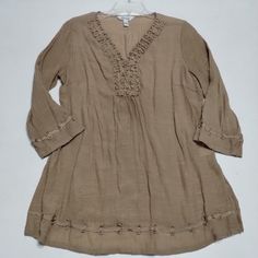 This Krazy Kat Tunic Top In Size Xl Is Perfect For Adding A Touch Of Boho Chic To Your Wardrobe. With A V-Neckline And 3/4 Sleeves, This Top Is Both Comfortable And Stylish. The Solid Brown Color And Peasant Theme Make It A Versatile Piece That Can Be Dressed Up Or Down. The Material Is A Mixture Of 60% Rayon And 40% Polyester And Features Ribbon Trim Accents. This Tunic Is Brand New With Tags And Is A Regular Size. Beaded Long Sleeve Summer Blouse, Spring Casual Embellished Blouse, Casual Embellished Spring Blouse, Casual Beaded Long Sleeve Top, Casual Long Sleeve Beaded Top, Bohemian Beaded V-neck Top, Beaded V-neck Bohemian Tops, Summer Embellished Beige Blouse, Casual Beaded Tops For The Beach