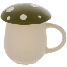 a white and green coffee cup with a mushroom on it