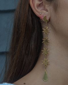 SWINGING STARS WHAT IT IS: Extra-long drop earrings consisting of bright gold dangling stars WHY IT’S SPECIAL: These magical earrings are made for daydreamers and moon chasers At 5" long, they're a sleek shiny statement, that is surprisingly easy to pull off GOOD TO KNOW: Hand-hammered brassSterling silver postsNickel- and lead-freeLength: 5” WHY WE LOVE WE DREAM IN COLOUR: Create a moment—every moment—you’re wearing We Dream in Colour. We love how they use all the hues of the rainbow and we are Magical Earrings, Star Earrings Dangle, Extra Long Earrings, Minimalist Studs, Thread Earrings, Gold Statement Earrings, Long Drop Earrings, Long Dangle Earrings, Bright Gold