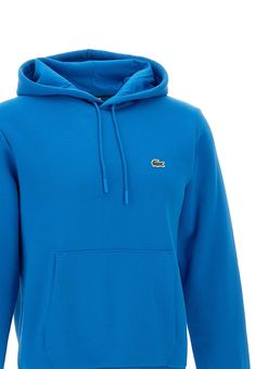 Lacoste 'Classics' men's organic cotton sweatshirt, turquoise, hood with drawstring and matching logoed finishes, kangaroo pocket on the front, ribbed edges, iconic crocodile logo patch on the chest, ideal for the autumn and winter season. Regular fit. Composition: 83% Cotton, 17% Polyester Casual Blue Hoodie With Logo Detail, Casual Blue Hoodie With Logo, Casual Hooded Tops With Logo Detail, Casual Solid Hoodie With Ribbed Collar, Casual Cotton Hoodie With Ribbed Collar, French Clothing Brands, René Lacoste, Crocodile Logo, Tennis Gear