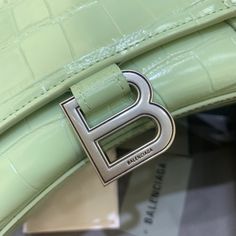 Description Balen Hourglass Small Handbag In Light Green, For Women, Bags 9in/23cm Rep 1:1 Size: 23 x 15 x 10 cm / 9 x 5.9 x 3.9 inches (Lenght x Height x Width) Handbag Curvilinear base One handle Adjustable and removable crossbody strap Studded magnet closure B logo hardware 1 back pocket 1 inner zipped pocket Includes box, dust bag. This product is of the best quality. Chanel Shirt, Balenciaga Bag, Small Handbag, Small Handbags, New Handbags, Crossbody Strap, Satchel Bags, Fashion Handbags, Adidas Shoes