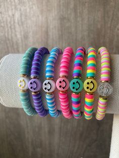 colorful bracelets with smiley faces and buttons on them