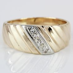 a yellow gold ring with diamonds on it