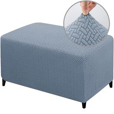 the footstool is covered with a blue blanket and has a round button on it