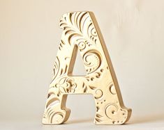 a carved wooden letter sitting on top of a table