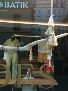 a display case with clothes hanging from it's sides