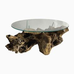 a glass table with driftwood on it