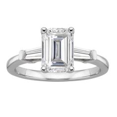 an emerald - cut diamond ring with baguetts on the shoulders and sidestones