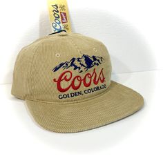 DETAILS: - Great-looking COORS BEER HAT for adults  - Tan with embroidered accents  - Officially licensed  - Unstructured crown with flat bill, retro 90s style   (new hat designed to look vintage) - Adjustable snapback - standard one size fits most adult  CONDITION: NEW WITH TAG   inventory ID#802401070TC2 Beer Hat, Corduroy Hat, Flat Bill Hats, Beer Shirts, 90s Style, Retro 90s, Look Vintage, Hat Designs, 90s Fashion