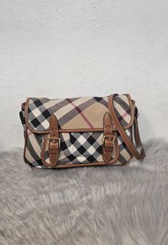 Burberry check crossbody bag. Features a spacious interior and two frontal buckle pockets. Flap cover and adjustable crossbody strap. Please view pictures and read descriptions before purchasing. Measurement: 13cm x 20 x 4cm Both exterior and interior are good. Light rubbing on edges and corners and mild scratches on hardware. Lovely piece. No dust bag, no damage and no added accessories. I offer free shipping. However, the buyer is   responsible for the custom fees. Sling Bags, View Pictures, Crossbody Strap, Cross Body Handbags, Purses And Handbags, Halloween Shopping, Crossbody Bags, Burberry, United Kingdom