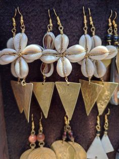 10 Well crafted  brass and bone earrings.  All same design  same sweet feeling with cowrie shell.  Wholesale price available up to a thousand pairs. Place your order thank you Handmade Bronze Jewelry For The Beach, Handmade Bronze Jewelry For Beach, Artisan Gold Earrings For Beach, Bohemian Cowrie Shell Earrings As Gift, Oromo Jewelry, Bohemian Cowrie Shell Earrings For Gift, Gold Cowrie Shell Earrings As Gift, Gold Cowrie Shell Earrings For Gift, Handmade Bohemian Cowrie Shell Earrings