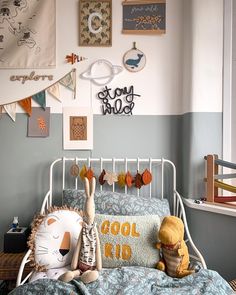 a child's bedroom with an iron bed frame and lots of pictures on the wall